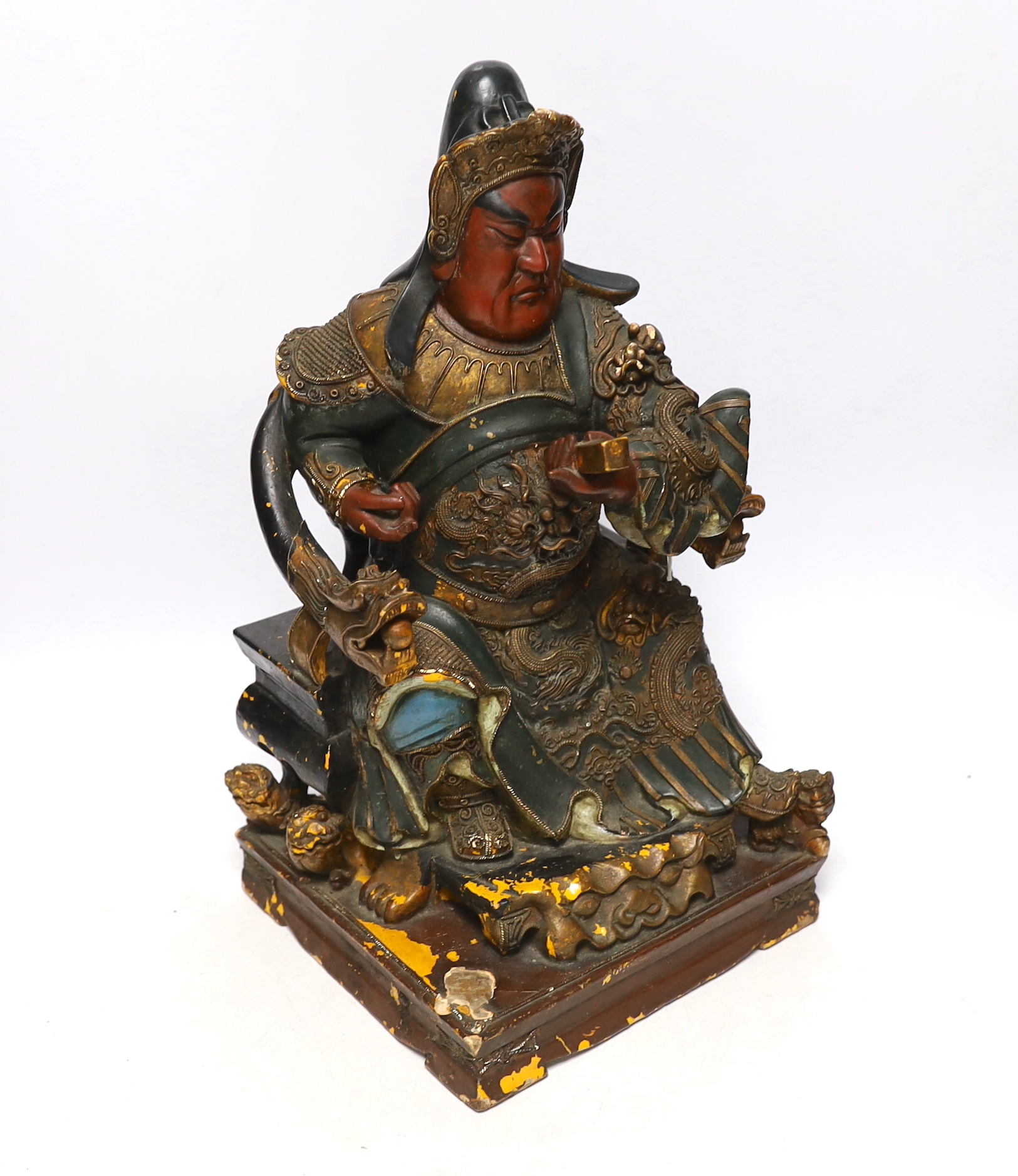 A 19th century Chinese polychrome wood and composition seated figure of Guandi, 41cm high